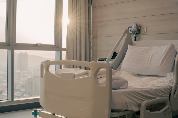 Empty patient bed at the hospital. Sick and healthcare concept.